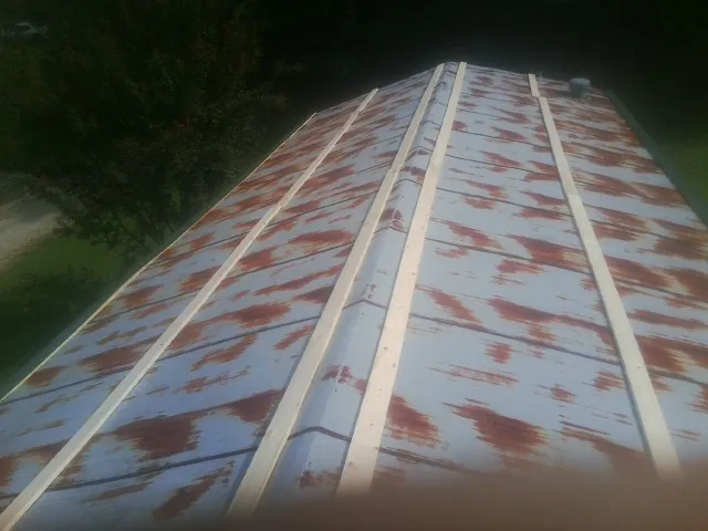 Rusted metal roof panels with new wood purlins before replacement — Storm Damage Roof Repair in Destin by Roofing Brothers